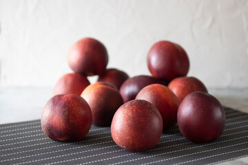 Ripe nectarines on a gray table.