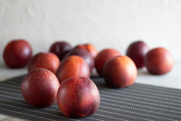 Ripe nectarines on a gray table.