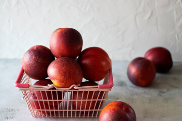 Ripe nectarines on a gray table.