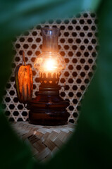 An oil lamp. 
It is a traditional lamp using an oil-based fuel source.