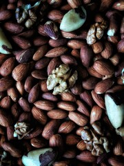 Background from assorted nuts. Walnut on almonds. Walnut wallpaper