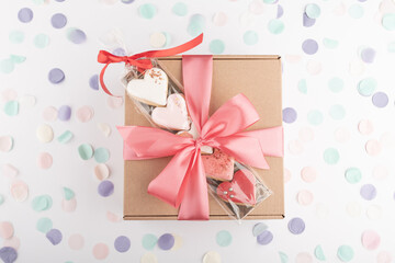 festive handcraft gift present box and heart shaped colorful cookies biscuits for Valentine's Day, Women's Day celebration. Top view