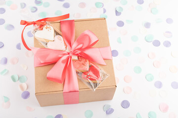 festive handcraft gift present box and heart shaped colorful cookies biscuits for Valentine's Day, Women's Day celebration. Top view
