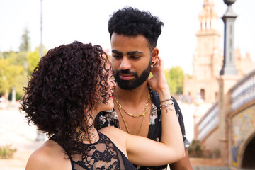 Couple of latin and bachata dancers dancing in a square. They are a young and handsome man and a...