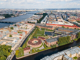 Fototapeta na wymiar Aerial panoramic view of New Holland island flooded with sunlight. Place for recreation in St Petersburg. City center on the background. Bridges of Saint Petersburg. Russia in the summer.