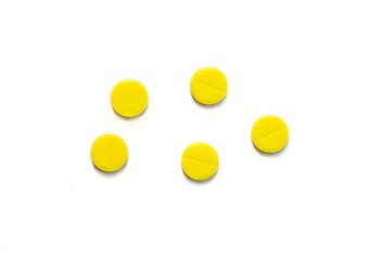 Bright yellow pills, medicine. Pills on a white background.