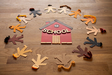 Detail of multi-ethnic paper dolls boys and girls claiming to be able to go to school in equality. Children's rights, human's rights.