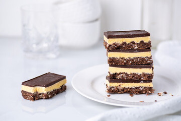 A stack of Nanaimo bars - a traditional Canadian dessert - in a white kitchen