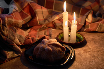 Traditional Mexican bread of the dead. Candle lighting. Enjoyed on the day of the dead. Mexican tradition concept.