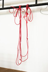 red rope hanging on the white wall background