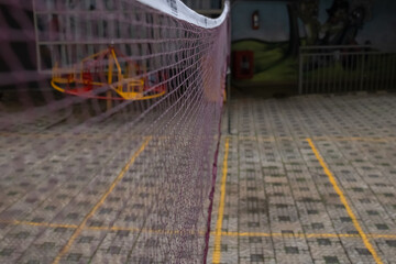 Badminton court with a brown net