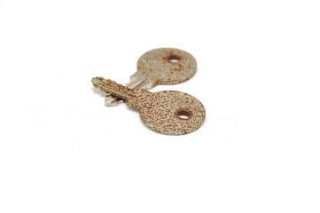 Vintage key on white background close-up. Texture, background, old, macro, wallpaper, metal, brass
