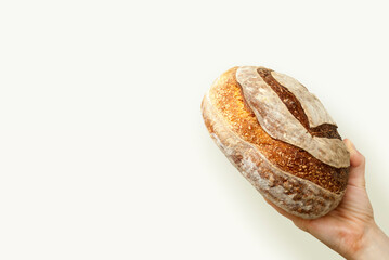 Female hand holding bread. Healthy food concept. Sourdough bread. Bread with a heart. Food concept....