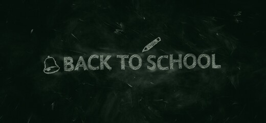 Green chalkboard background with words ‘Back to school’ handwritten in white chalk.