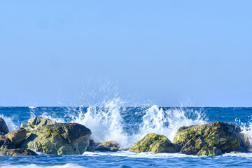 Sea waves splash over the breakwater in the Mediterranean Sea
