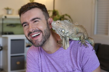 Young man and his gorgeous green iguana pet - Powered by Adobe