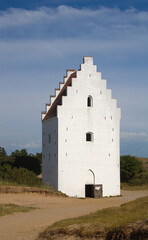 Fototapeta na wymiar White tower in the dunes, the Sand-buried Church, Skagen, Denmark
