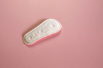 panty liner, women's hygiene product on pink paper texture © chrupka