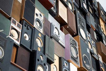 Collection of many vintage loudspeakers on a wall. Retro interior music sound box. Nostalgia music...