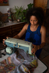 Latin woman, sewing with an old machine