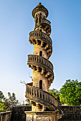 Fototapeta na wymiar Spiral staircase around ancient stone pillar at Mohabbat Maqbara