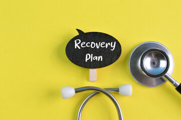 Stethoscope and wooden speech bubble with text RECOVERY PLAN