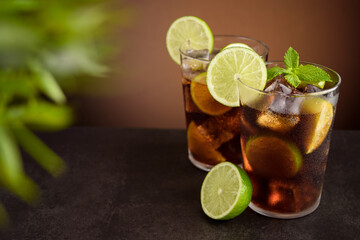 Cuba Libre cocktail. Alcoholic drink with cola, rum, lime and mint. Cuba Libre or long island iced tea cocktail.