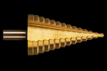 Conical step drill for drilling holes of different diameters, isolated on black background