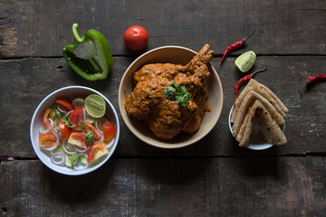 Murg makhani or butter chicken prepared with chicken breast, onion, garlic and whole Indian spices served with paratha. A rich gravy item.
