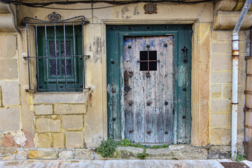 Fototapeta na wymiar Hondarribia, Spain - 29 Aug 2021: An old wooden door on a traditional Basque home in old town Hondarribia