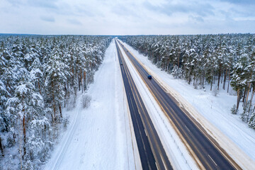 Aerial bird-eye view on freeway road in the winter field