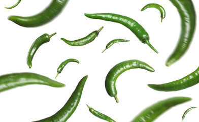 Green chili peppers falling on white background