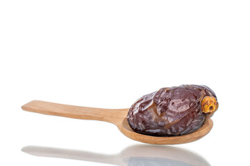 One royal date with a wooden spoon, close-up, isolated on white.