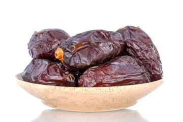 Several royal dates on a ceramic dish, close-up, isolated on white.