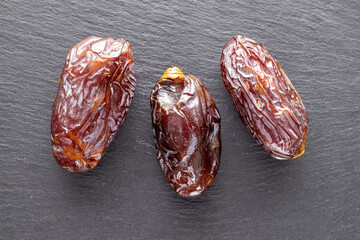 Three royal dates on a slate stone, close-up, top view.