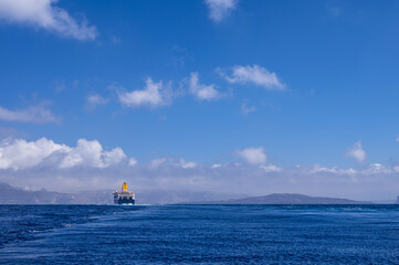 Cruise ship near Santorini island in Aegea sea, Greece. Ferry sailing to port. Transportation by sea.