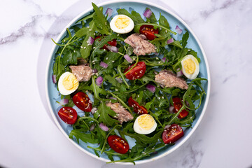 fresh salad with canned mackerel, arugula and tomatoes