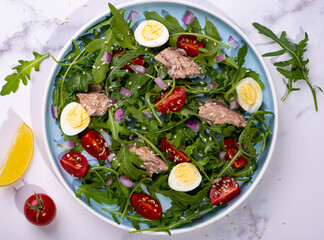fresh salad with canned mackerel, arugula and tomatoes