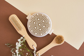 three wooden brushes with natural bristles for dry massage of the face, body and feet, pedicure and facial massage