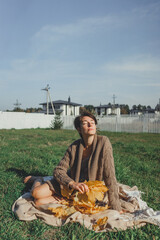 Fototapeta na wymiar Autumn picnic: girl knitted sweater
