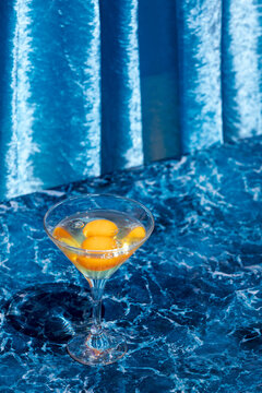Glass with raw eggs on table