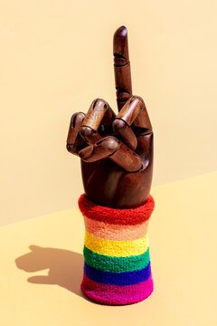 Mannequin hand with fuck gesture and LGBTQ wristband