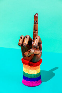 Mannequin hand with fuck gesture and LGBTQ wristband
