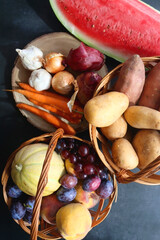 Various seasonal fruit and vegetable on dark background. Top view.