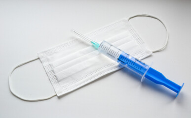 Mask. Syringe and needle. White background