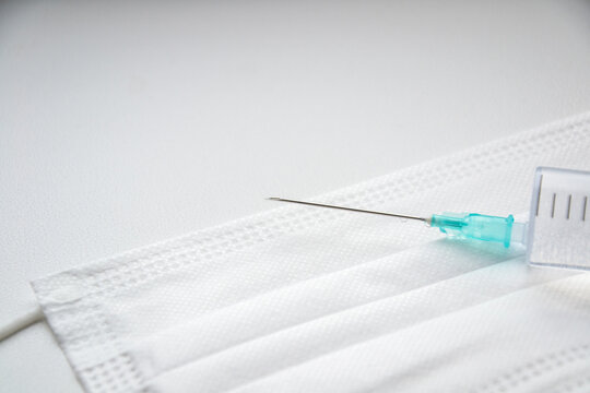 Mask. Syringe and needle. White background