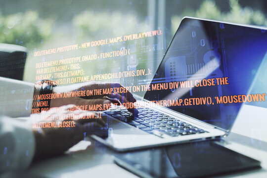 Double exposure of abstract programming language hologram with hands typing on laptop on background, research and development concept