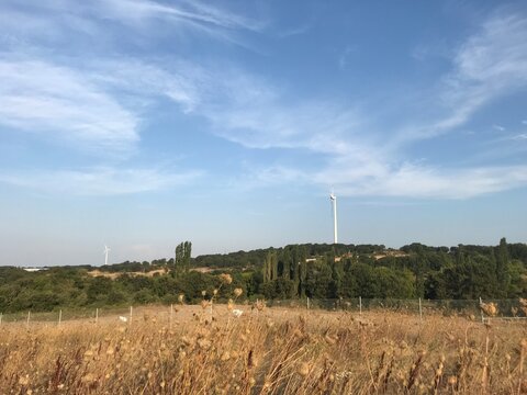 wind mills with couldy sky