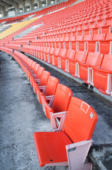 Empty orange seats at stadium,Rows walkway of seat on a soccer stadium