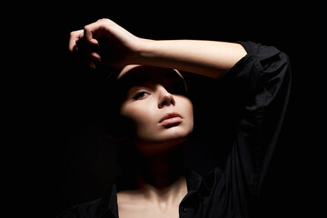 Fashion portrait of young beautiful woman in dark